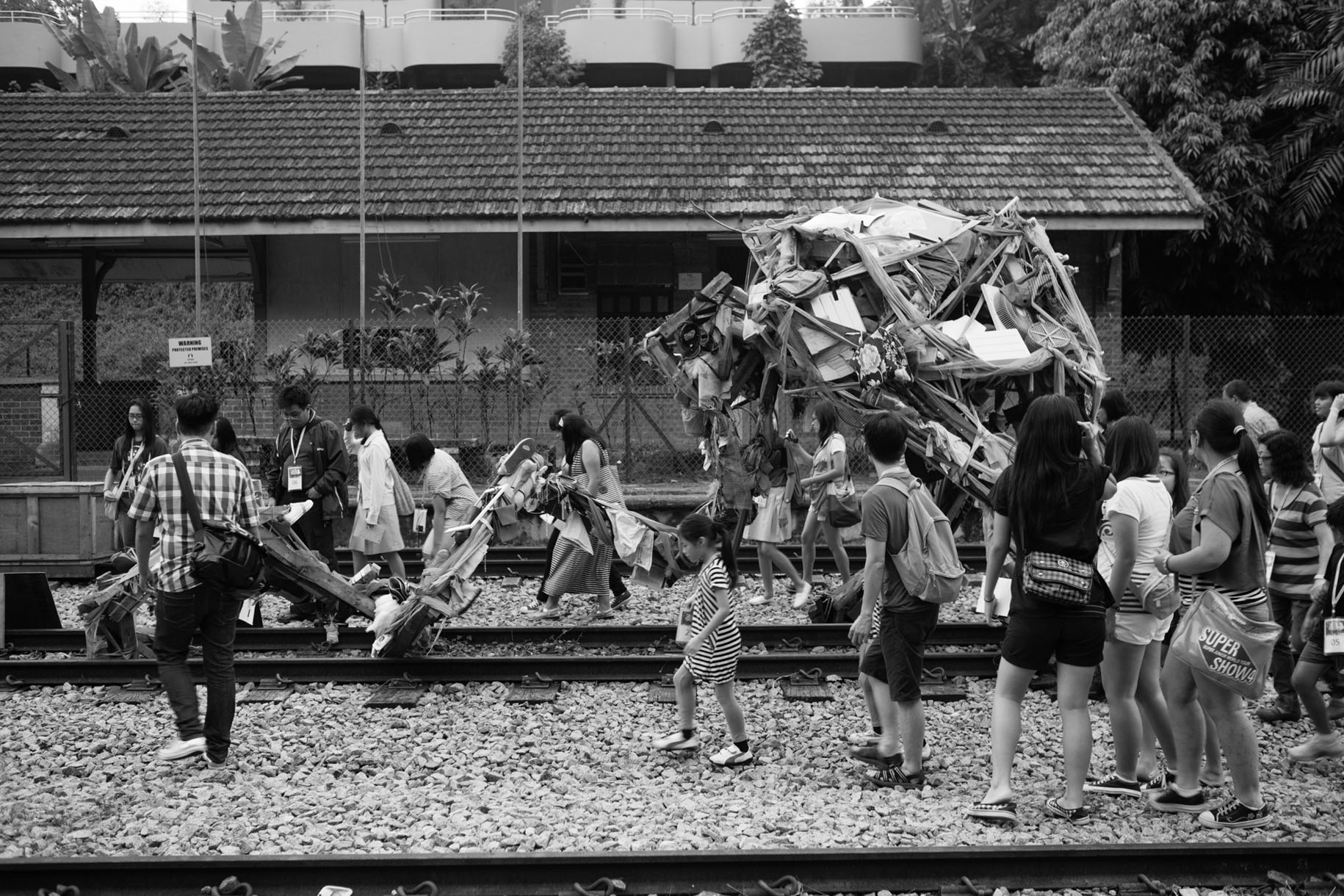 <p><em><a href="https://drlib.lasalle.edu.sg/319/">Project Mending Sky</a></em>: US is Drama Box’s third and final production in their Community Art Project on Environment. Delivered in both English and Mandarin, involving 32 performers and 10 production staff, this was an innovative work, experiential and site-specific, leading the audience from sunset to nightfall, on a physical and imaginative journey through one-and-a-half kilometres of what remains of the historic Bukit Timah Forest.</p>
<p>Bukit Timah Forest was once an untouched forest where wildlife, including tigers, roamed free; the history of this environment is revealed through the various installations and performances as participants journey on the pretext of a search for the legendary “Bukit Timah Monkey Man”, recorded in 1805 and last spotted in 2007.</p>
